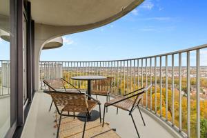 a balcony with chairs and a table with a view at ma suite -NEW-23Floor-FantasticView-Center in Augsburg +8 photos