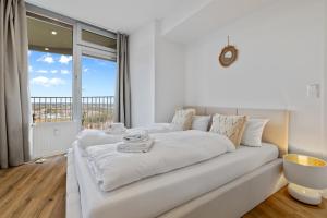 a white couch in a room with a large window at ma suite -NEW-23Floor-FantasticView-Center in Augsburg