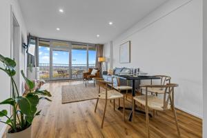 a living room with a table and chairs and a couch at ma suite -NEW-23Floor-FantasticView-Center in Augsburg