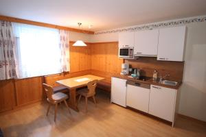 una cucina con tavolo e sedie in una stanza di Liftgasthof Appartements a Zauchensee