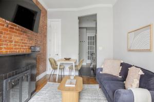 a living room with a couch and a fireplace at West Village 1br w wd nr local park NYC-1262 in New York