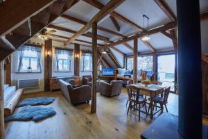 a large living room with a table and chairs at Božská usedlost in Prackov