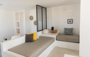 a living room with two beds and a window at Lemon Tree Houses in Ano Meria