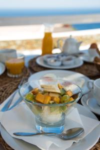 a bowl of food sitting on a table with a plate at Lemon Tree Houses in Áno Meriá