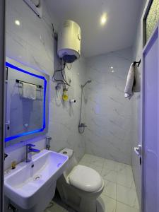a bathroom with a white toilet and a sink at خيال بارك in Baish +17 photos