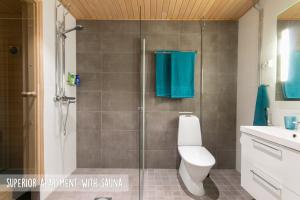 a bathroom with a shower with a toilet and a sink at Piriko Apartments in Rovaniemi +30 photos