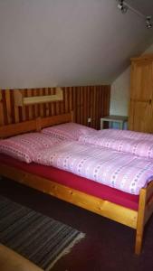 a bedroom with a wooden bed in a room at Holiday home in Jestrabi v Krkonosich 2207 in Roudnice