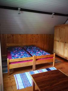 a bedroom with a bed and a table at Holiday home in Jestrabi v Krkonosich 2207 in Roudnice