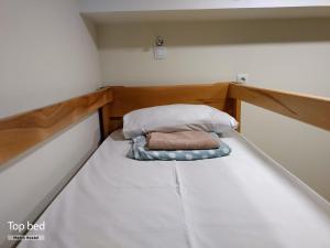 a small bed in a small room at Metro Hostel in Yerevan
