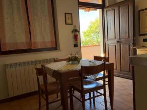 a dining room with a table and chairs and a window at 8380 Miracolle apartments in Poggio Murella