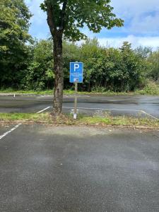 um sinal de estacionamento azul na berma de uma estrada em Moderne und komfortable Appartements im Ferienpark Hahnenklee em Hahnenklee-Bockswiese