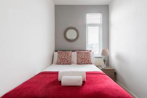 a bedroom with a large bed with a red blanket at Contractor Group relocation accommodation Birmingham in Birmingham