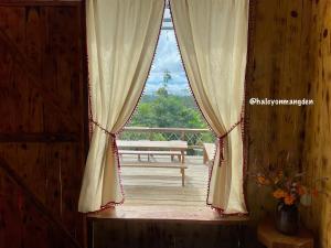 a window in a room with a wooden deck at Halcyon Homestay Mang Den in Kon Von Kla