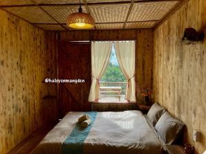 a bedroom with a bed with a teddy bear on it at Halcyon Homestay Mang Den in Kon Von Kla