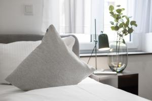a pillow sitting on top of a bed with a window at ma suite - Augsburg City in Augsburg
