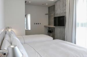 Letto o letti in una camera di CityInn Hotel Plus- Fuxing North Road Branch