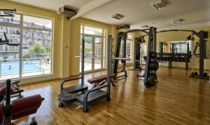 a gym with several tread machines and a pool at Hotel Belle View in Kranevo