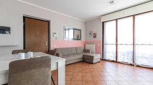 a living room with a couch and a table at Piazza Alboreto 72 - Rozzano in Rozzano