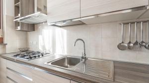 a kitchen with a sink and a stove at Piazza Alboreto 72 - Rozzano in Rozzano