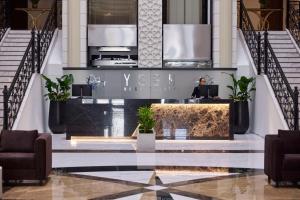 a lobby with a reception desk in a building at Yogh Hospitality in Paramaribo