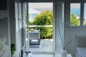 an open door to a patio with a table at Lemon Tree Houses in Áno Meriá