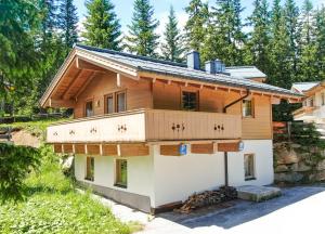 a house with a balcony on top of it at Chalet Hochkrimml 141 in Krimml