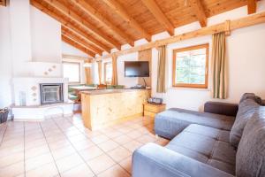 a living room with a couch and a fireplace at Chalet Hochkrimml 141 in Krimml