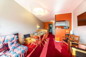 a living room with a table and a couch at Le Sosna - IMMODREAMS - Avoriaz in Avoriaz