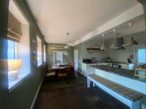 a kitchen with a long counter and a dining room at Old Boathouse Upper Lough Erne in Fairfield