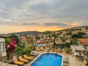 a villa with a swimming pool and a city at Cyprus Villages Hotel & Restaurant - Central Location - Bed & Breakfast - With Access To Pool And Stunning Views in Tochni