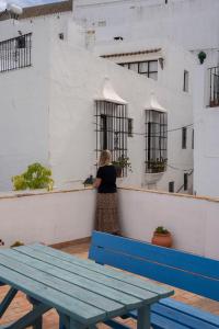 a woman standing on the ledge of a building at Casa Brigitte - Califa Casas Vejer in Vejer de la Frontera
