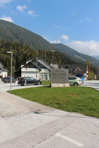 a sign in front of a parking lot with cars at Apartment Simona in Kranjska Gora