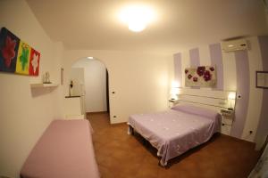 A bed or beds in a room at B&B Le Colline Country House