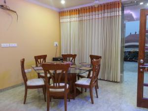 a dining room with a wooden table and chairs at LAVISH Fully Furnished HOMESTAY - ISH, Atithya with various free amenities in Lucknow, INDIA in Lucknow