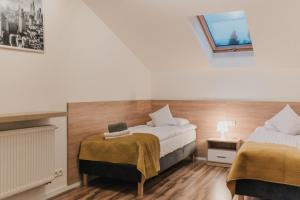 Postel nebo postele na pokoji v ubytování APARTAMENTY PRZY PARKU- Parking GRATIS!!!