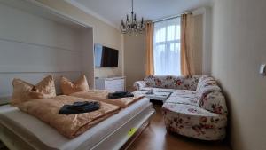 a living room with a couch and a couch and a chair at Ferienwohnung Fürst Metternich in Bad Elster in Bad Elster