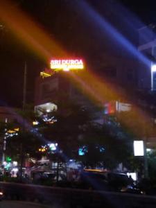 un'insegna al neon in cima a un edificio di notte di Sri Durga Luxury A/C Rooms,Sircilla a Sirsilla