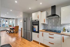 a kitchen with stainless steel appliances and a dining room at Finest Retreats - The Lookout in Ilfracombe