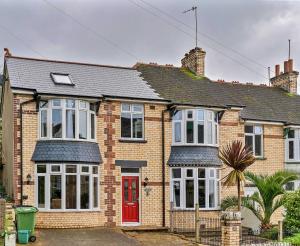 a brick house with a red door at Finest Retreats - The Lookout in Ilfracombe