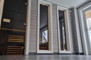 a row of glass doors on a building at Fantastisk Stuga i Hälsingland, Los! in Los