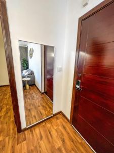 a hallway with a mirror and a door at Micro Sea View Aprt غرفة و صالة in Jeddah