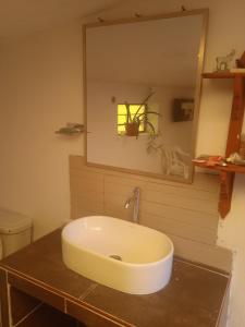 a bathroom with a sink and a mirror at Casa de campo hospedaje RyM in Sicuani
