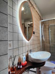 a bathroom with a sink and a mirror at Appartamento Fontesecco in LʼAquila