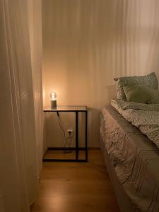 a table with a candle on it next to a bed at Bronx - Apartment in Vantaa +9 photos