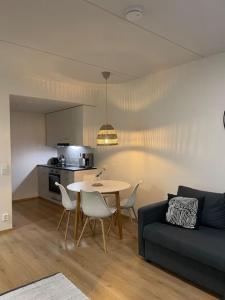 a living room with a table and a couch at Bronx - Apartment in Vantaa