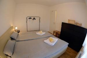 a bedroom with a bed with two towels on it at Apartman Blue moon in Velika Mlaka