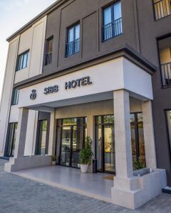 un bâtiment avec un panneau d'hôtel à l'avant dans l'établissement SIBB Hotel, à Tirana