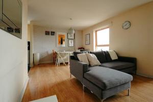 a living room with a couch and a table at Luxurious Top Floor 2 Bedroom by Westfield and ABBA! in London