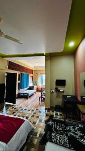 a room with a bed and a living room at Sana Estate Stay in Madikeri