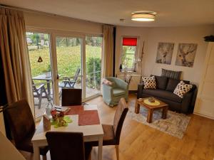 a living room with a couch and a table at Apartment Kleiner Heinrich in Braunlage